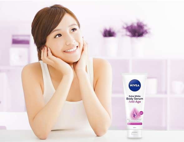 woman smiling with NIVEA body serum